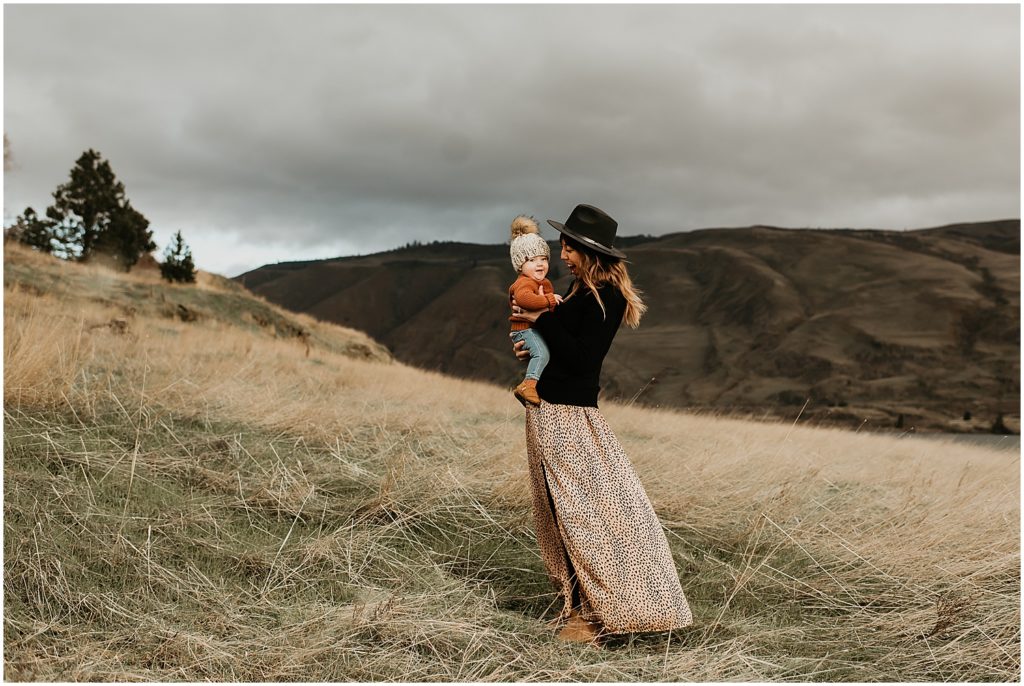 mom and baby both wearing hats and snuggling