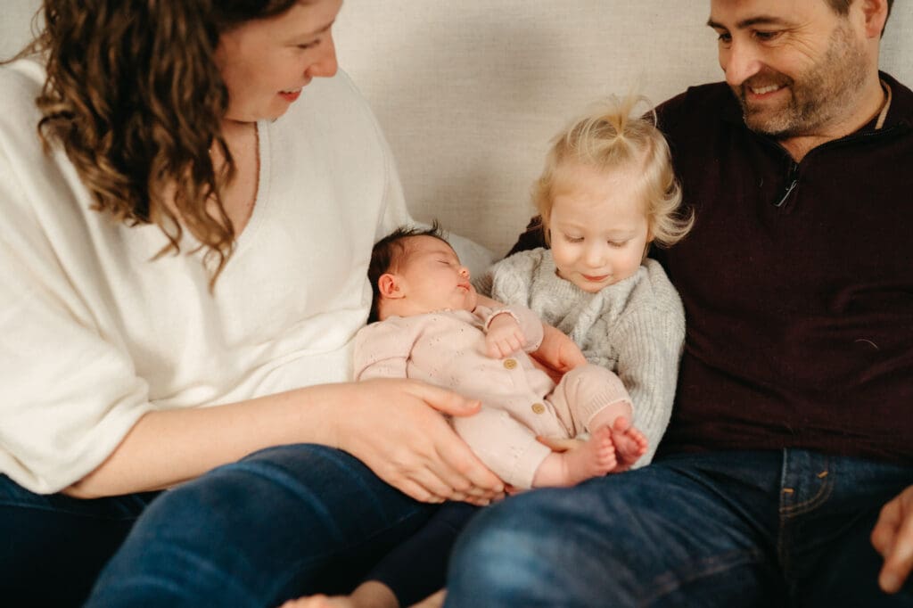 i
i
intimate in-home newborn photography session capturing a tender moment between parents and their baby, emphasizing connection and authenticity.