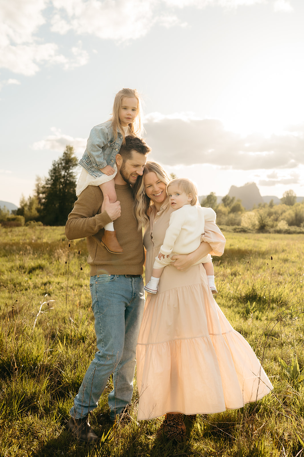 family snuggled up for spring photos during golden hour