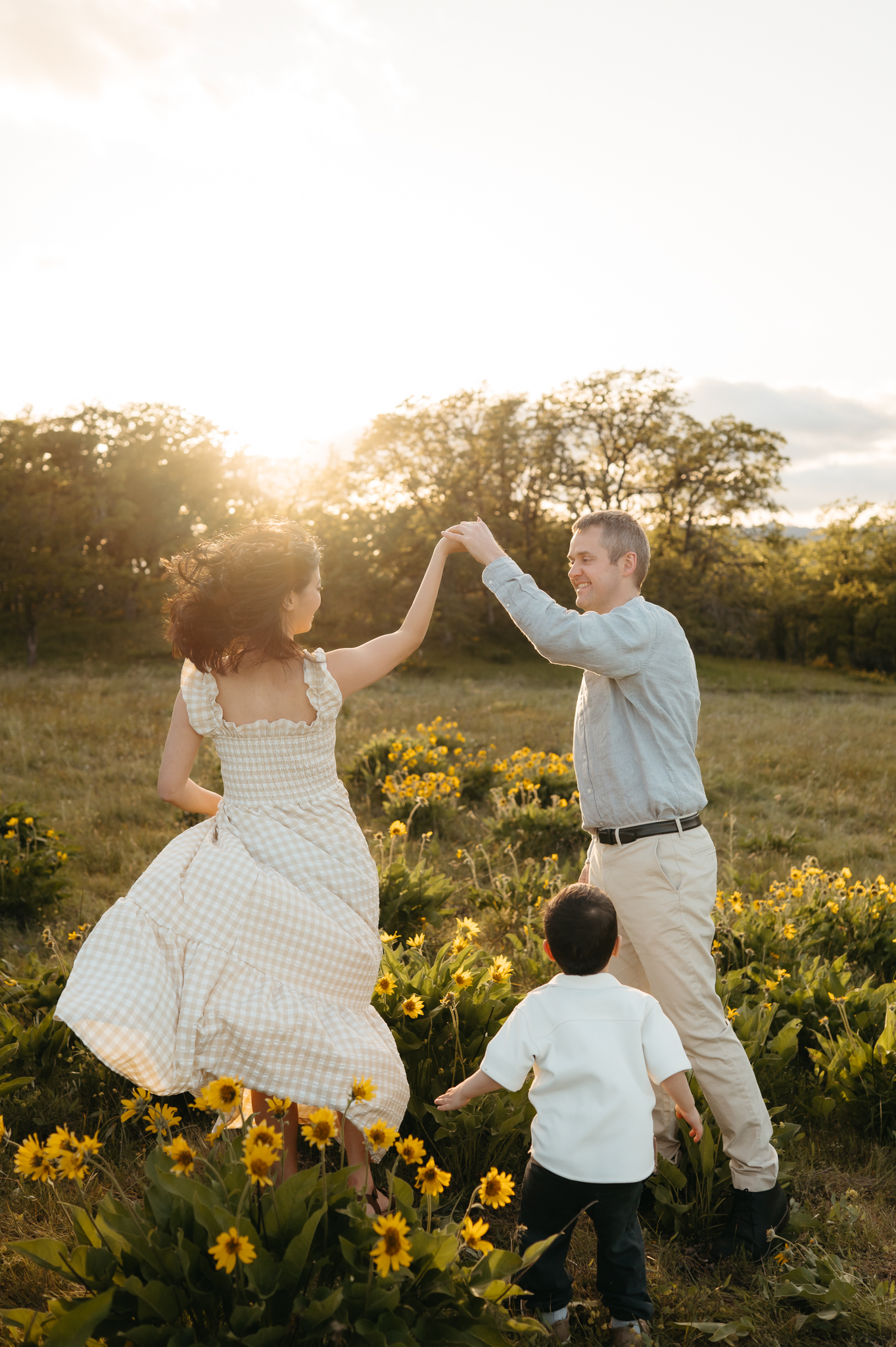 portland family in the wildflowers of the columbia river gorge twirling and playing