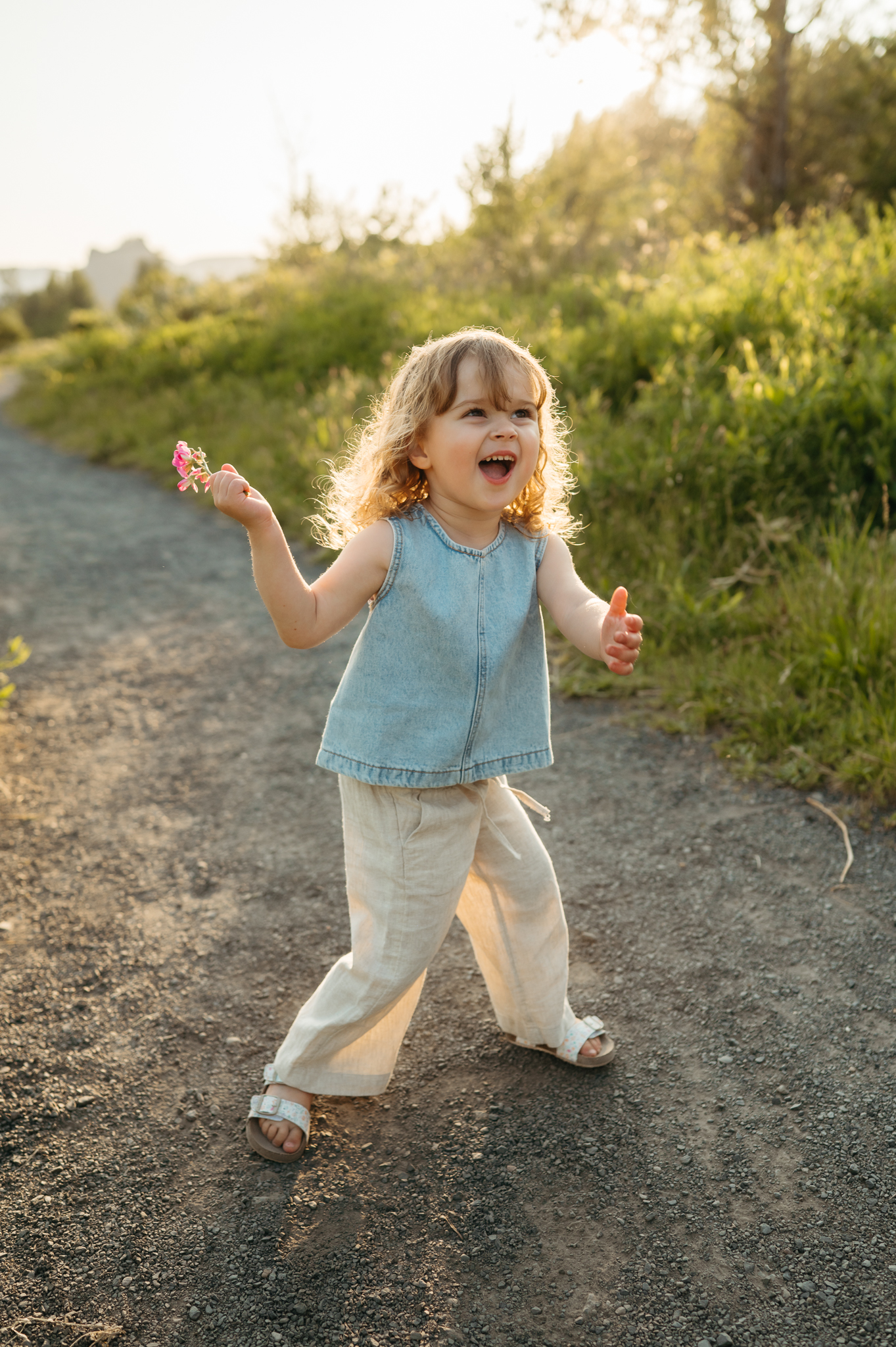 portland kid being joyful with golden light behind her in the columbia river gorge